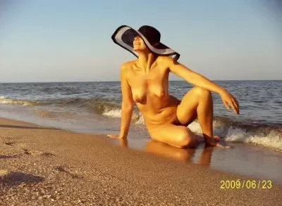 Дама в шляпе на берегу моря обнажённая (5 фото)